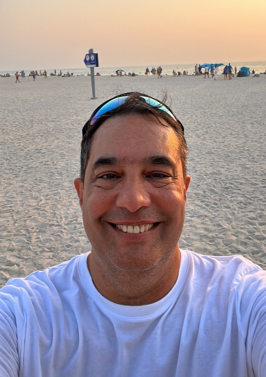 Patrick, the founder of Where Does My Money Go, on a beach at sunset.